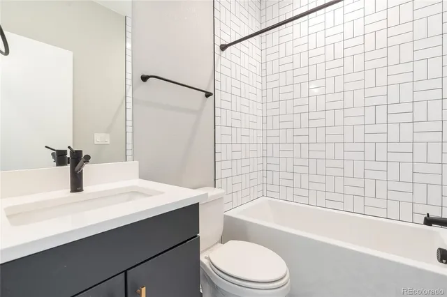 a bathroom with a sink a toilet and bathtub