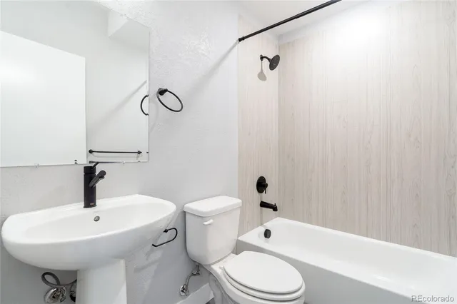 a bathroom with a sink a toilet and a bathtub