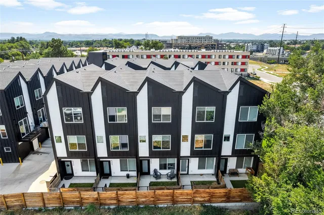 a view of a brick building next to a lake