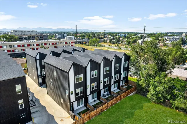a view of a balcony with chairs and a yard