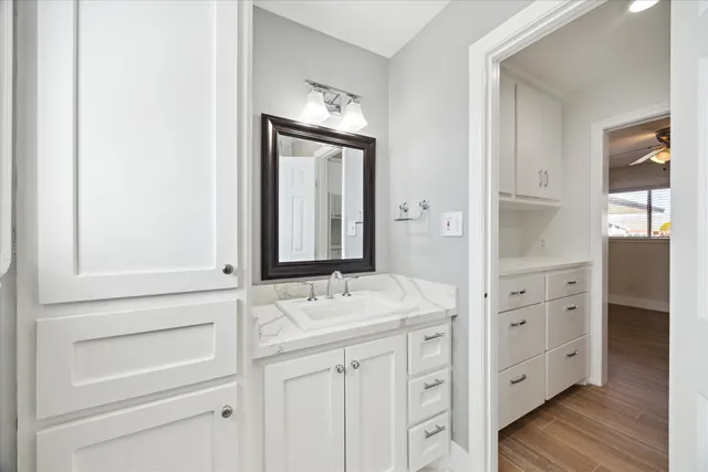 a bathroom with a sink vanity and mirror