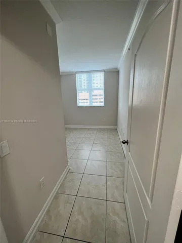 a view of a room with white door and cabinet