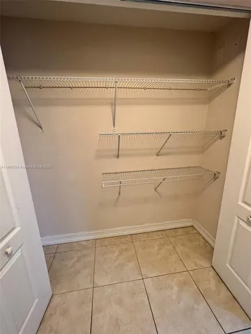 a bathroom with a granite countertop sink a toilet a mirror and shower