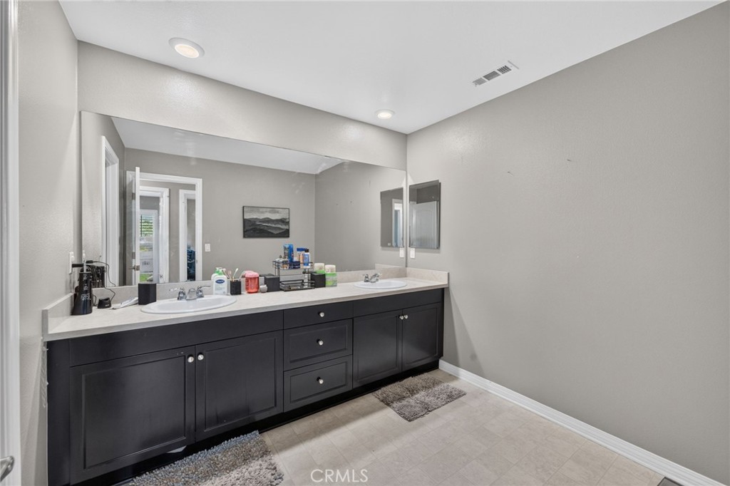 23347 Crystal Way Wildomar, CA 92595 - Photo 61 of 109 a bathroom with a double vanity sink and mirror