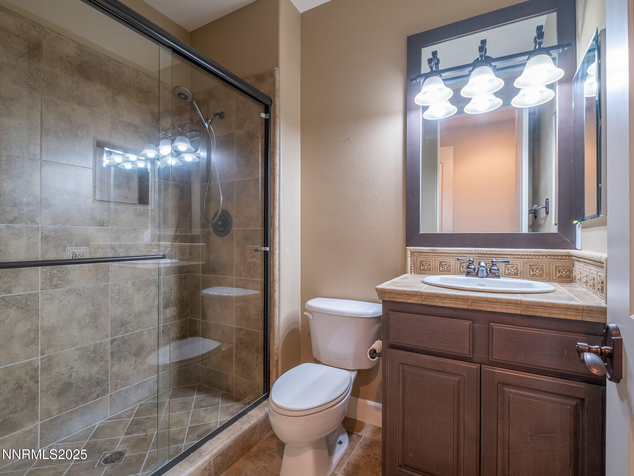 3985 San Donato Loop Reno, NV 89519 - Photo 18 of 29 a bathroom with a toilet sink and mirror