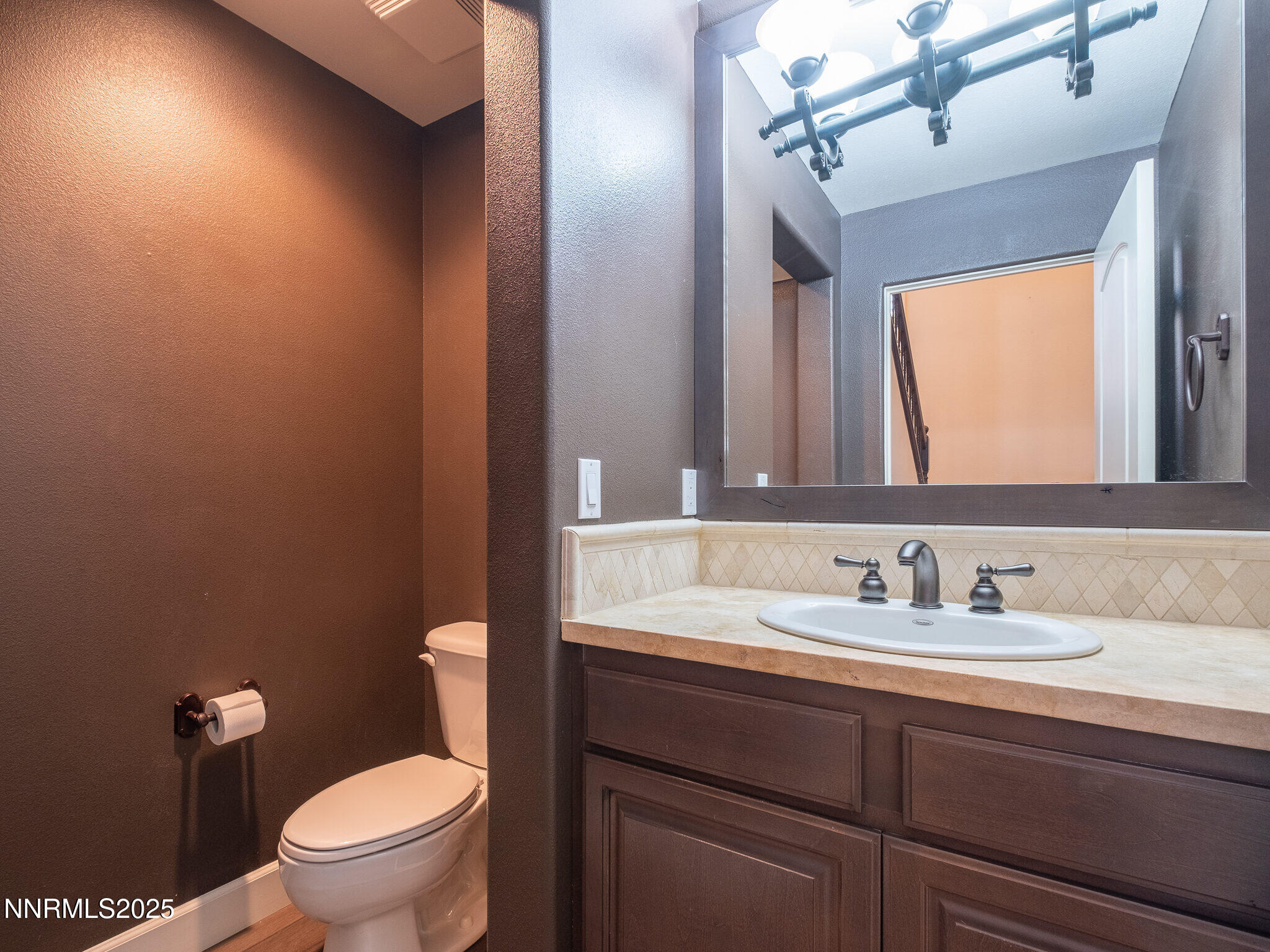 3985 San Donato Loop Reno, NV 89519 - Photo 21 of 29 a bathroom with a toilet sink and mirror