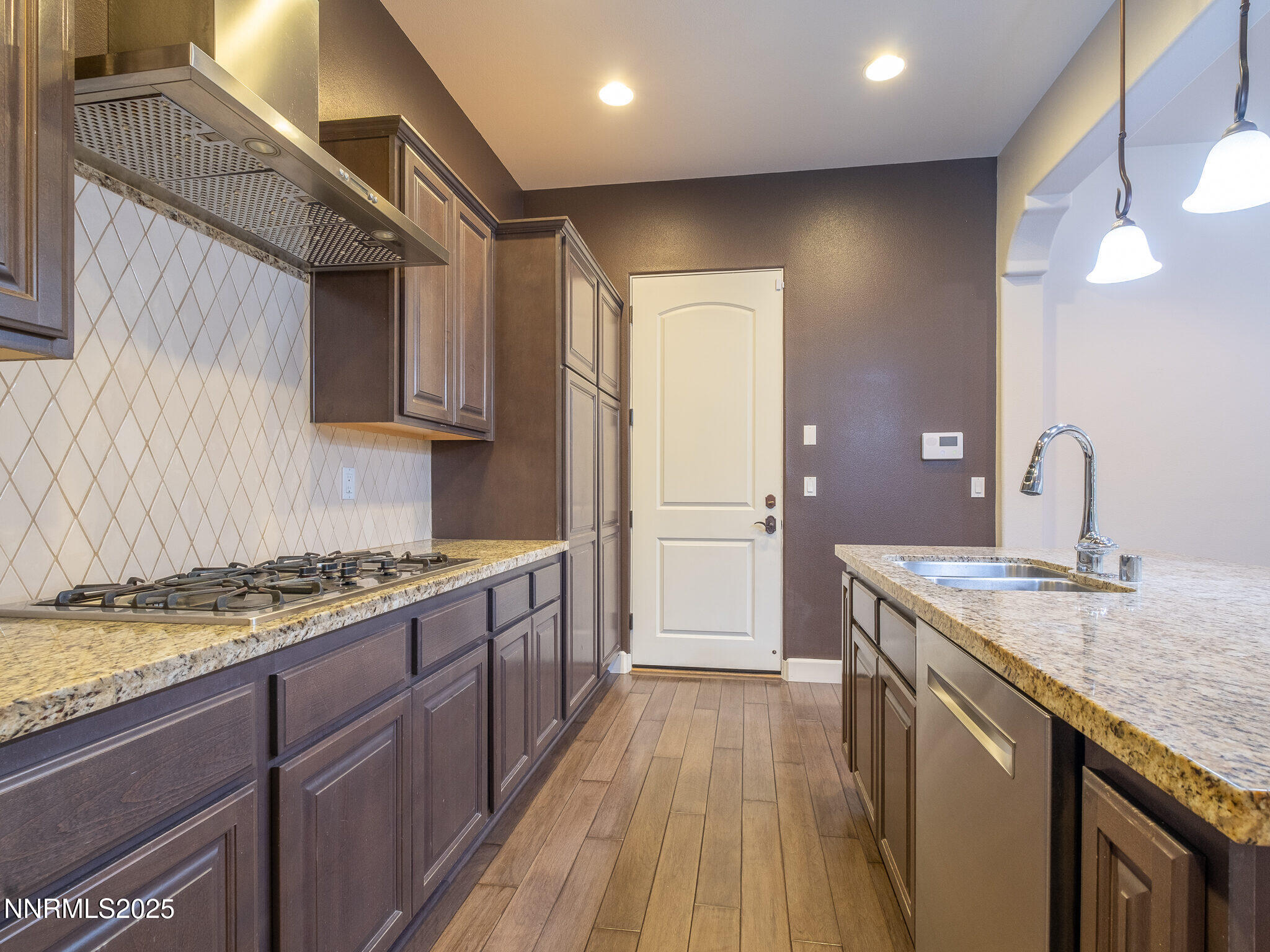 3985 San Donato Loop Reno, NV 89519 - Photo 23 of 29 a kitchen with a sink stove and cabinets