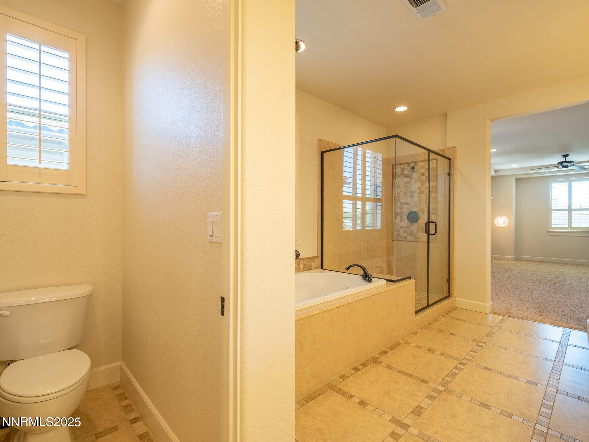 3985 San Donato Loop Reno, NV 89519 - Photo 25 of 29 a spacious bathroom with a granite countertop toilet a sink and bathtub