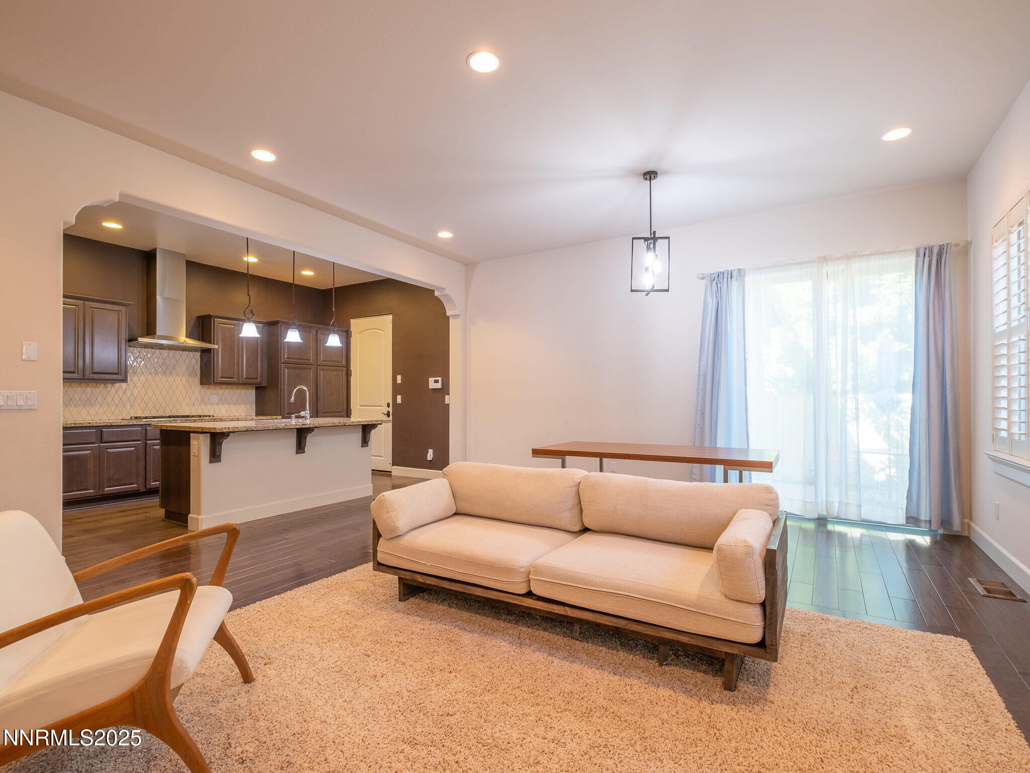3985 San Donato Loop Reno, NV 89519 - Photo 3 of 29 a living room with furniture and a chandelier