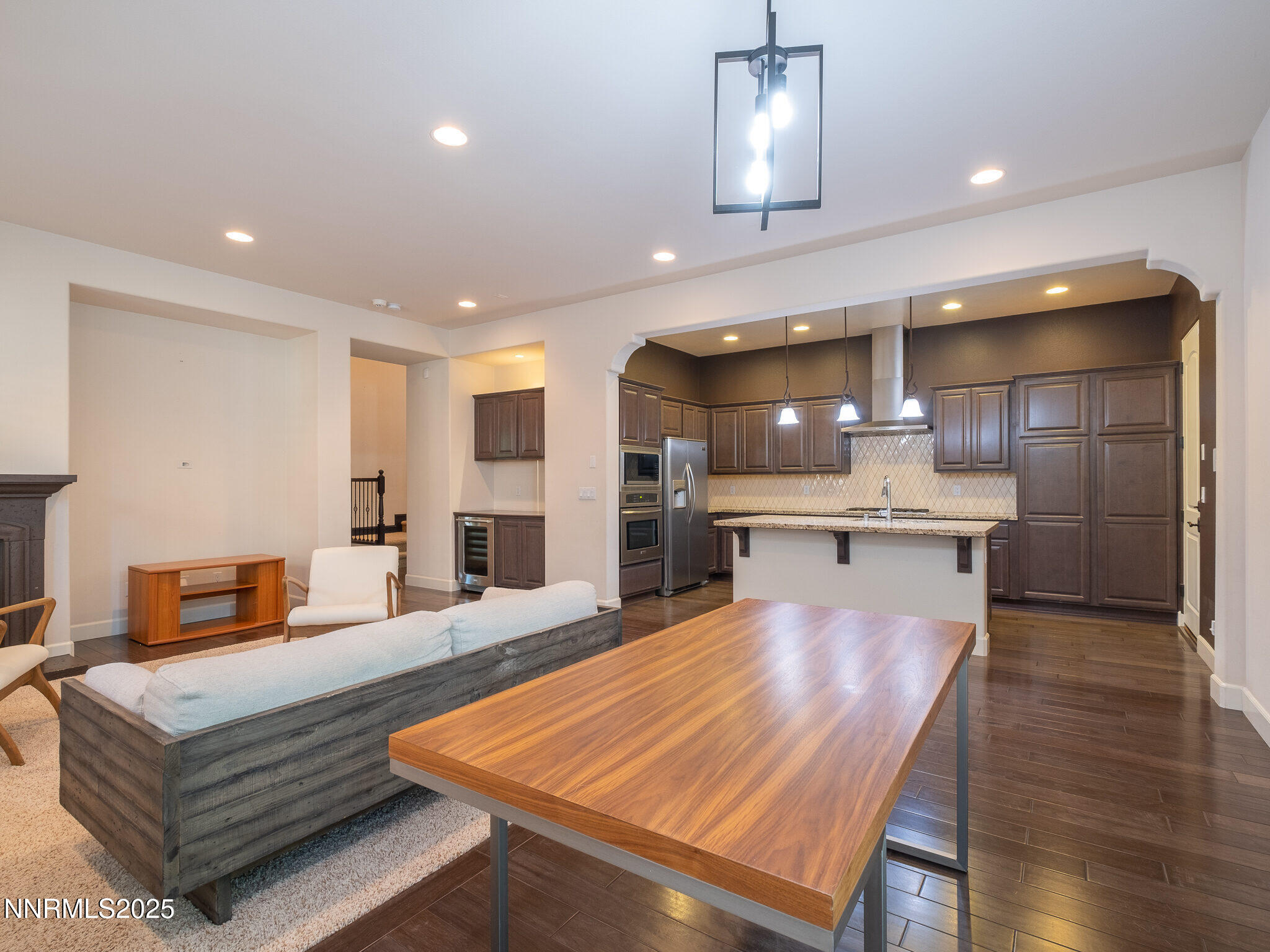 3985 San Donato Loop Reno, NV 89519 - Photo 6 of 29 a living room with stainless steel appliances kitchen island a large island in the center