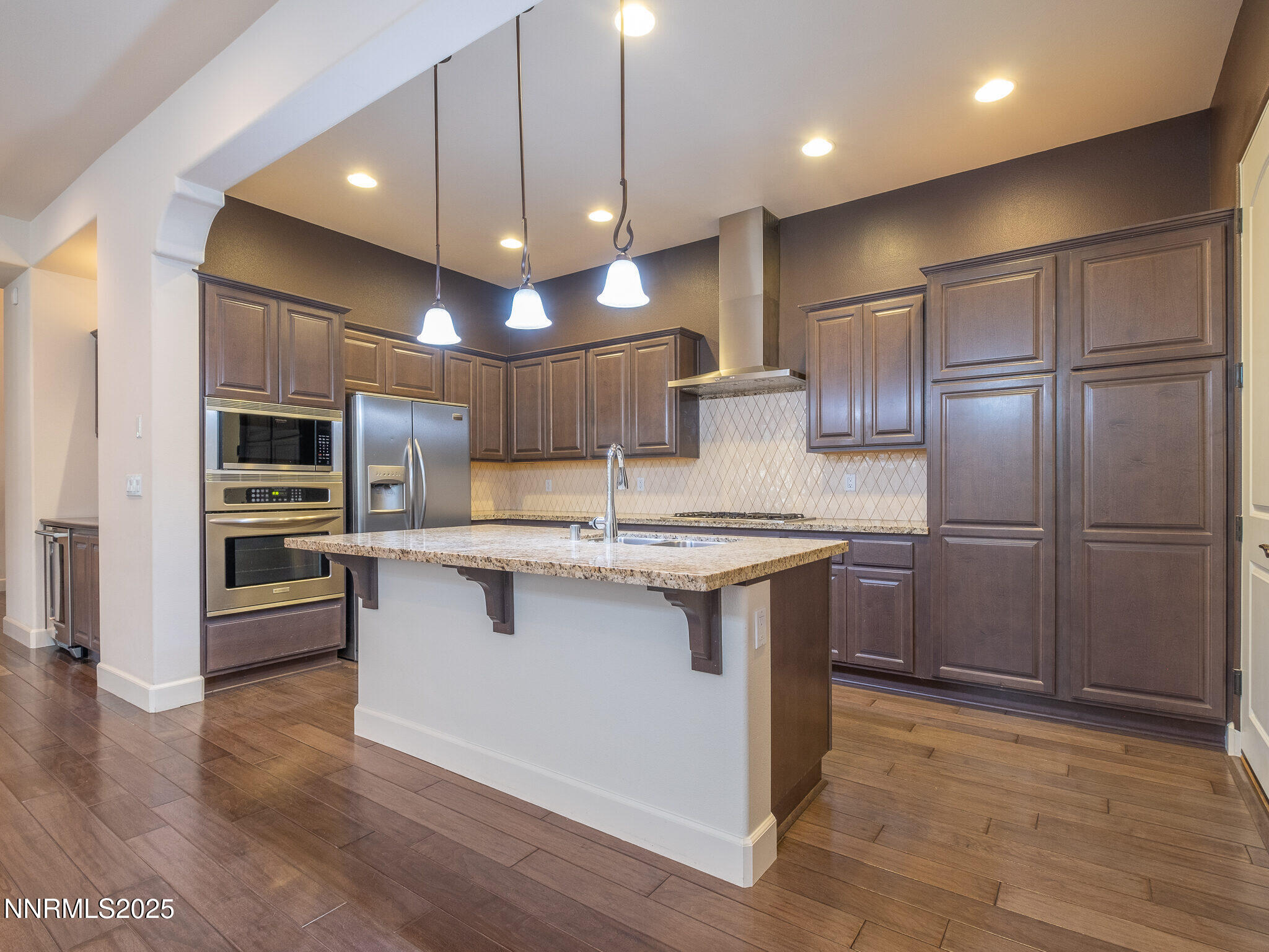 3985 San Donato Loop Reno, NV 89519 - Photo 7 of 29 a kitchen with stainless steel appliances granite countertop a sink a stove and a refrigerator