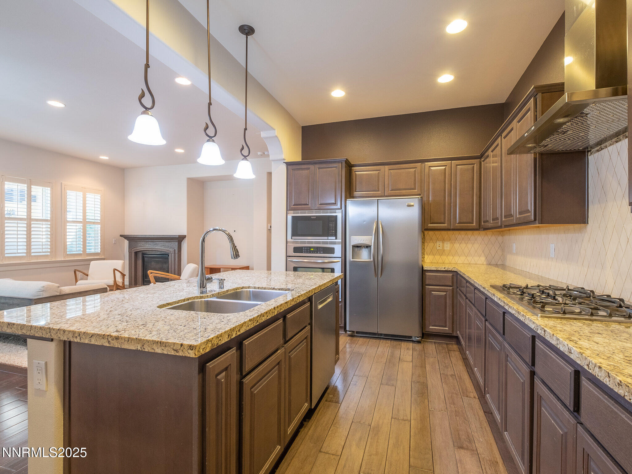 3985 San Donato Loop Reno, NV 89519 - Photo 8 of 29 a kitchen with stainless steel appliances granite countertop a sink a stove and a refrigerator