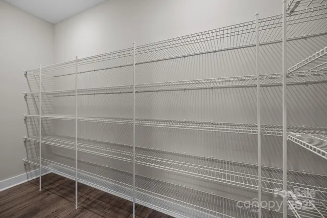 a view of a room with wooden floor and windows
