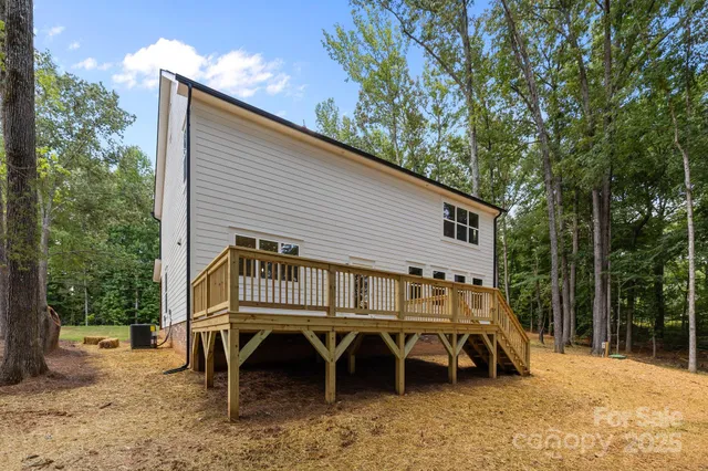 a front view of a house with a yard and deck
