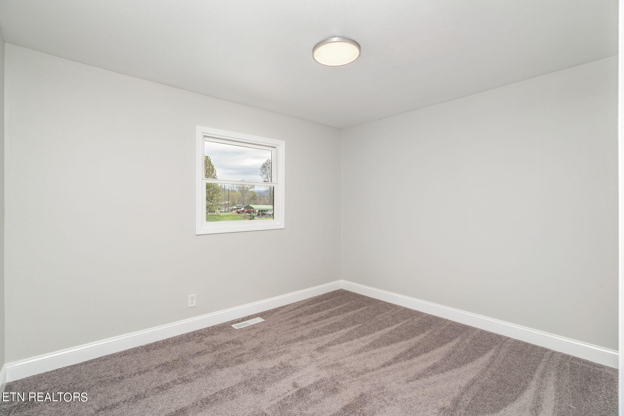 218 Oakmont Road Bean Station, TN 37708 - Photo 21 of 32 an empty room with wooden floor and windows