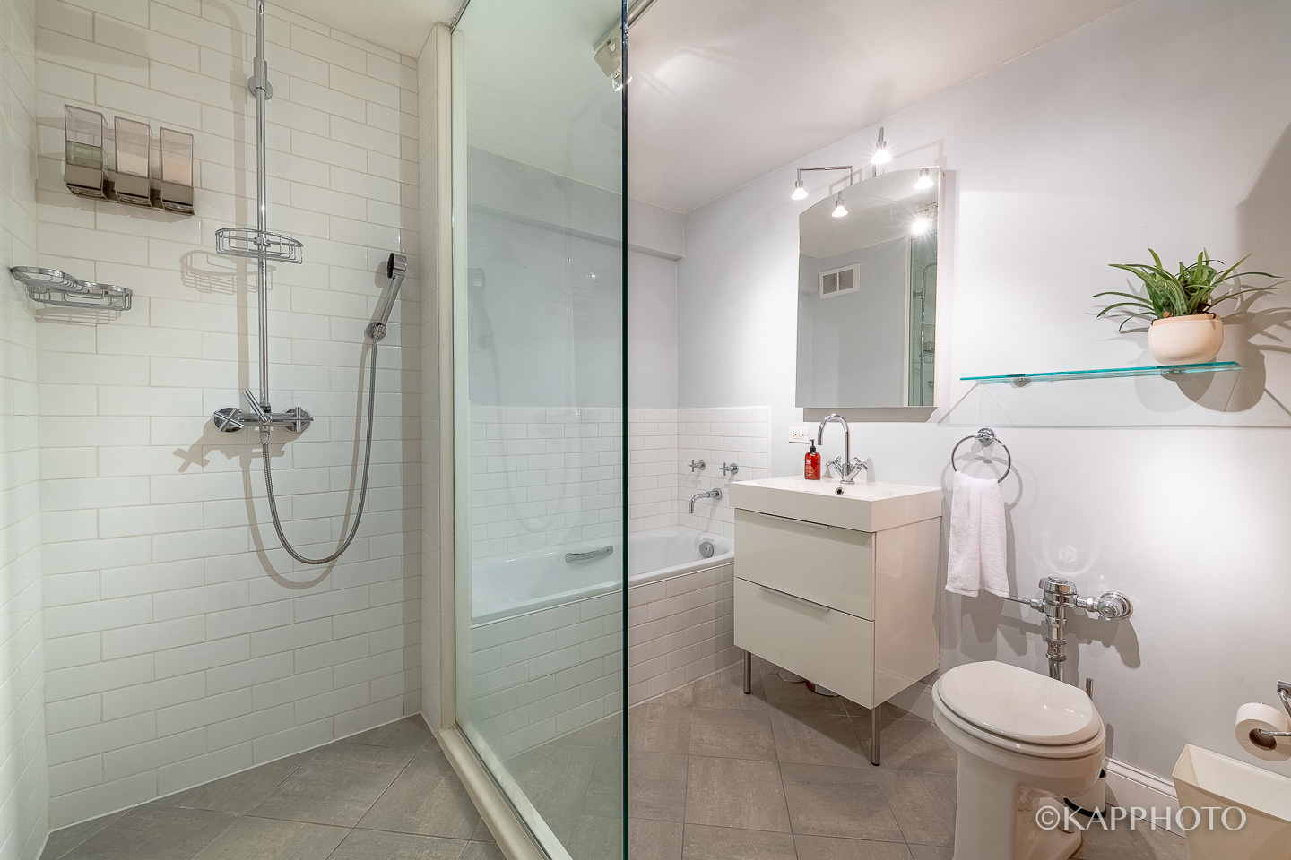 2909 North Sheridan Road, Unit 1807 Chicago, IL 60657 - Photo 13 of 23 a bathroom with a sink toilet and shower