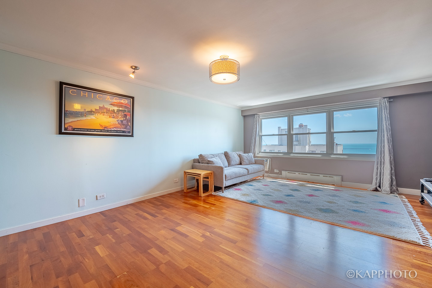 2909 North Sheridan Road, Unit 1807 Chicago, IL 60657 - Photo 4 of 23 a view of empty room with wooden floor and fan