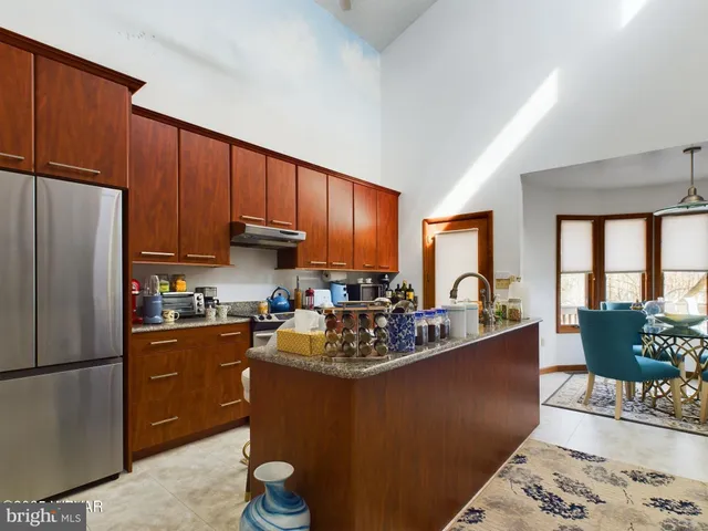 a kitchen with stainless steel appliances granite countertop a refrigerator sink and cabinets
