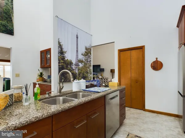 a bathroom with granite countertop a sink and a mirror