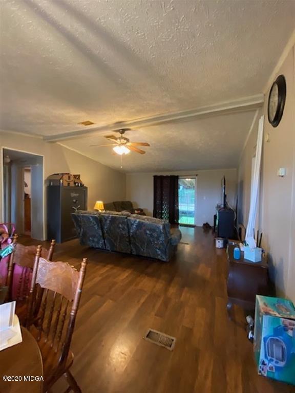 1155 Macedonia Church Road Cochran, GA 31014 - Photo 11 of 22 a living room with furniture and a large window