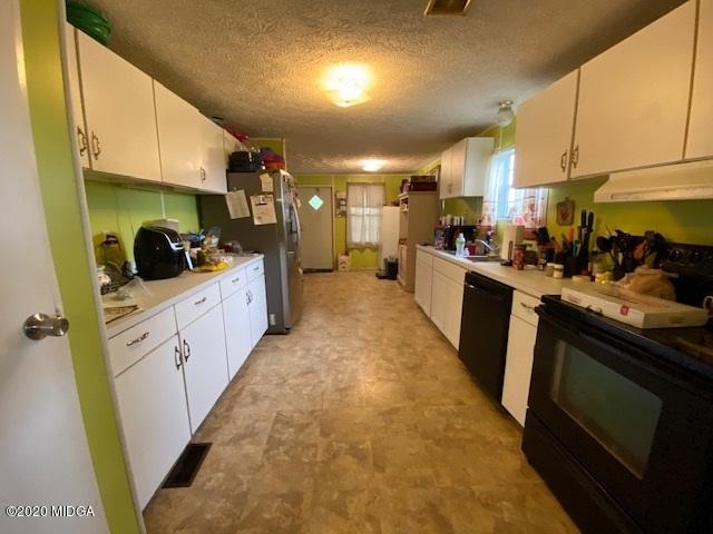 1155 Macedonia Church Road Cochran, GA 31014 - Photo 12 of 22 a kitchen with stainless steel appliances kitchen island granite countertop a stove and a sink