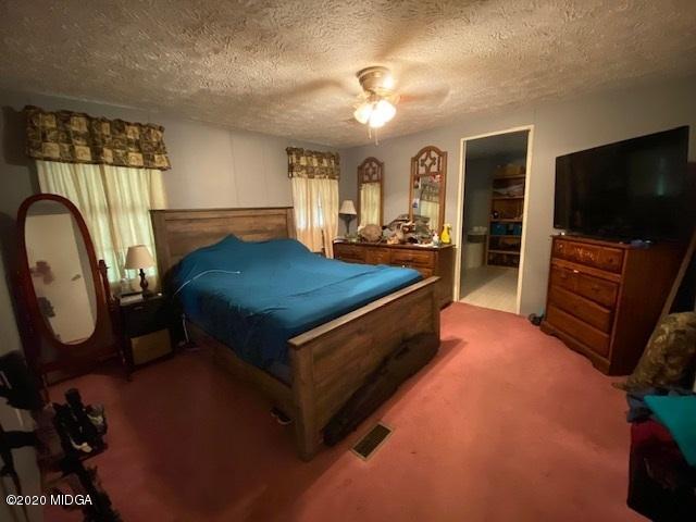 1155 Macedonia Church Road Cochran, GA 31014 - Photo 13 of 22 a bed room with furniture and a flat screen tv