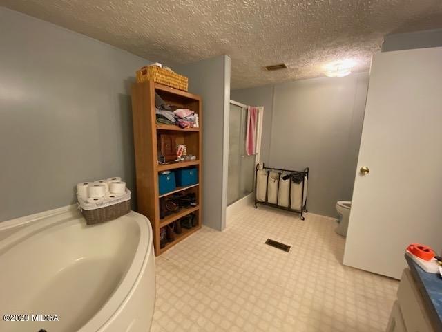 1155 Macedonia Church Road Cochran, GA 31014 - Photo 16 of 22 a bedroom with a bed and furniture