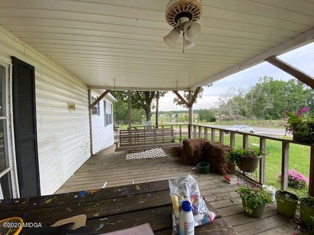 1155 Macedonia Church Road Cochran, GA 31014 - Photo 6 of 22 a view of a patio with table and chairs potted plants