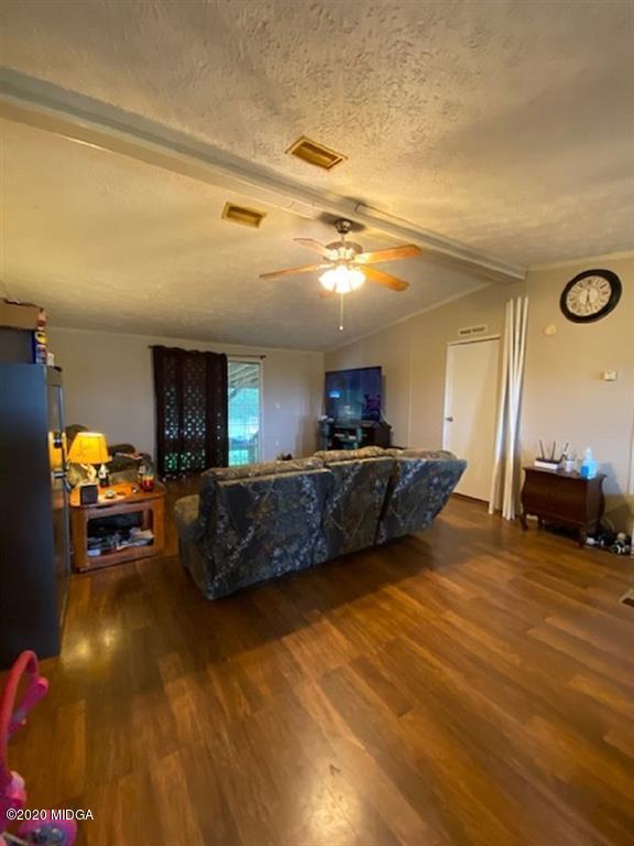 1155 Macedonia Church Road Cochran, GA 31014 - Photo 8 of 22 a living room with furniture and a flat screen tv