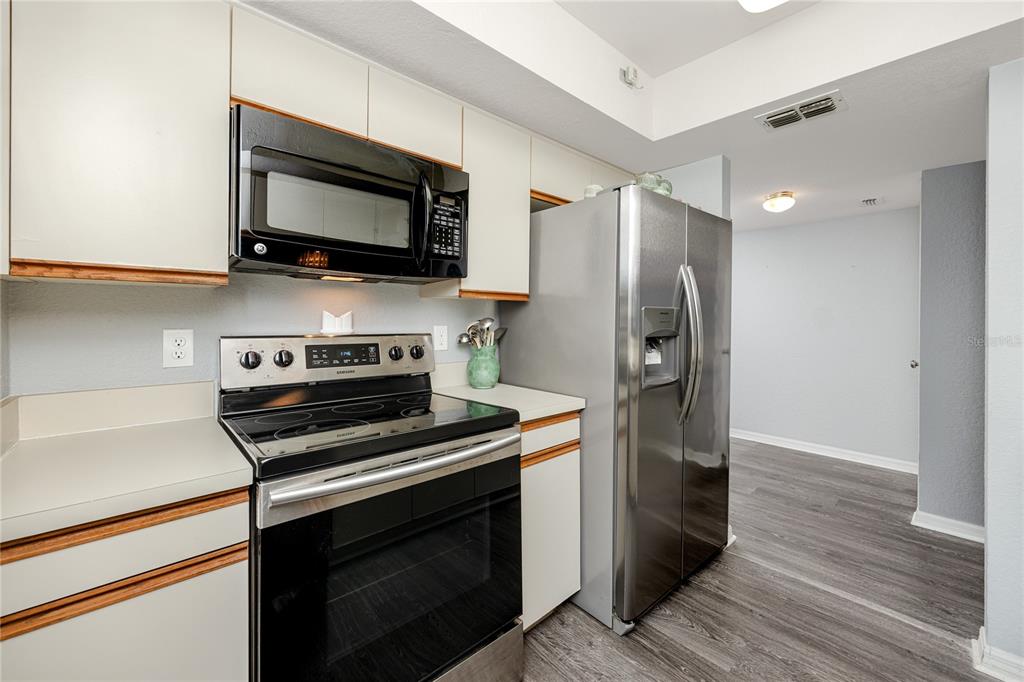816 Hidden Harbour Drive Indian Rocks Beach, FL 33785 - Photo 13 of 58 a kitchen with a stove and a microwave