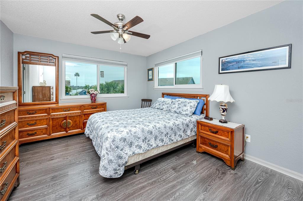 816 Hidden Harbour Drive Indian Rocks Beach, FL 33785 - Photo 22 of 58 a bedroom with a bed and a chandelier