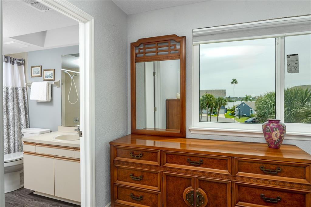 816 Hidden Harbour Drive Indian Rocks Beach, FL 33785 - Photo 23 of 58 a bathroom with a sink a mirror and a window