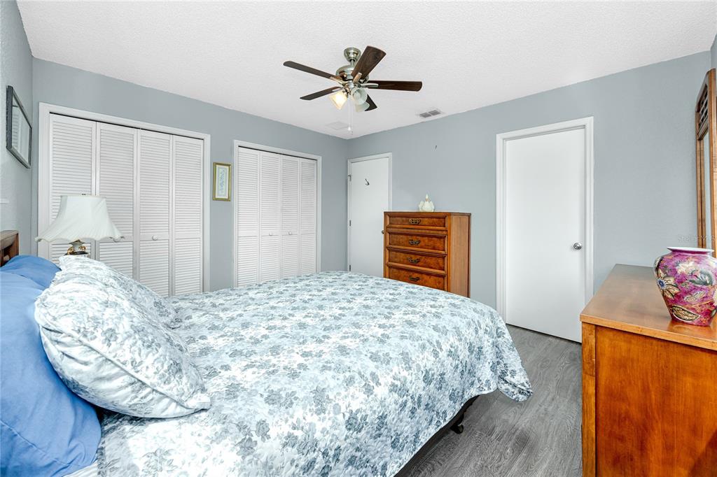 816 Hidden Harbour Drive Indian Rocks Beach, FL 33785 - Photo 24 of 58 a bedroom with a bed and wooden floor