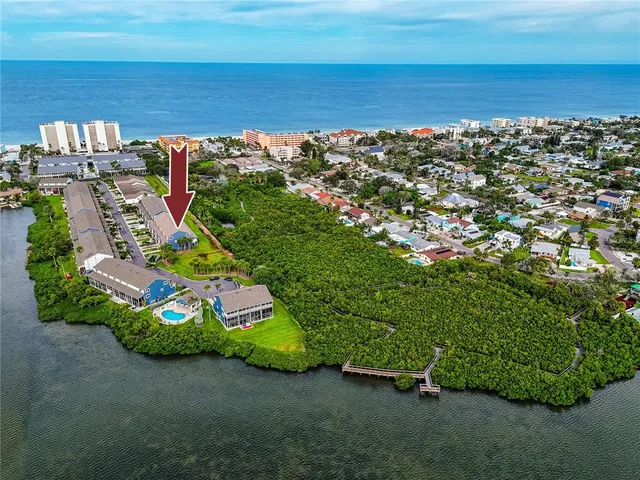 an aerial view of a house with a lake view