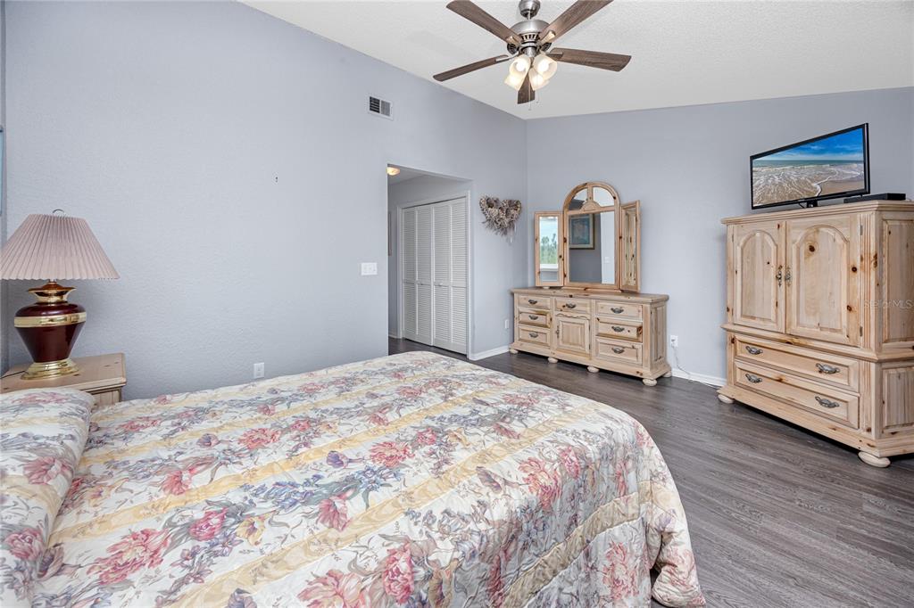 816 Hidden Harbour Drive Indian Rocks Beach, FL 33785 - Photo 33 of 58 a bedroom with a bed and a chandelier