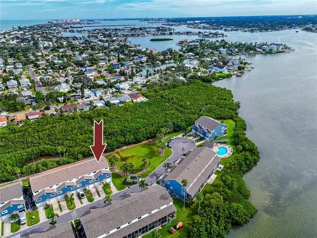 a front view of a house with balcony and garden