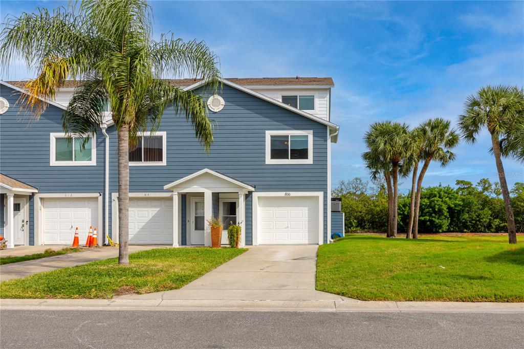 816 Hidden Harbour Drive Indian Rocks Beach, FL 33785 - Photo 5 of 58 a front view of a house with a yard and garage