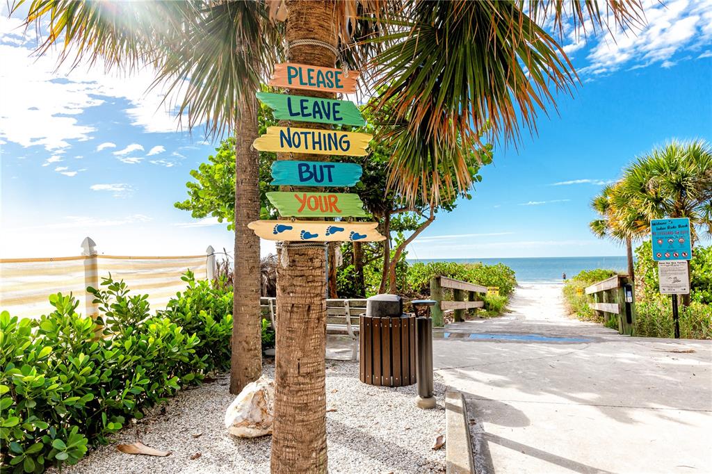 816 Hidden Harbour Drive Indian Rocks Beach, FL 33785 - Photo 55 of 58 a street sign with potted plants and palm trees