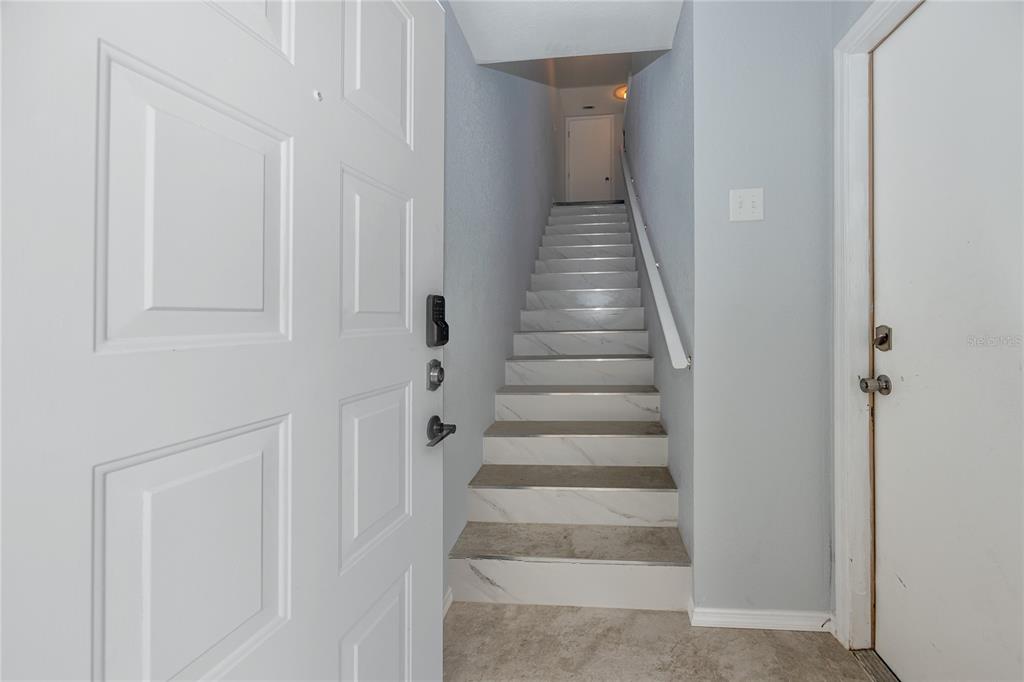 816 Hidden Harbour Drive Indian Rocks Beach, FL 33785 - Photo 6 of 58 a view of a hallway with wooden floor and entryway