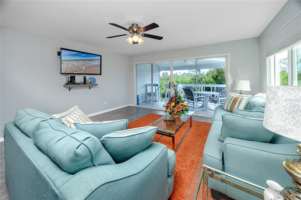 816 Hidden Harbour Drive Indian Rocks Beach, FL 33785 - Photo 7 of 58 a living room with furniture and a large window