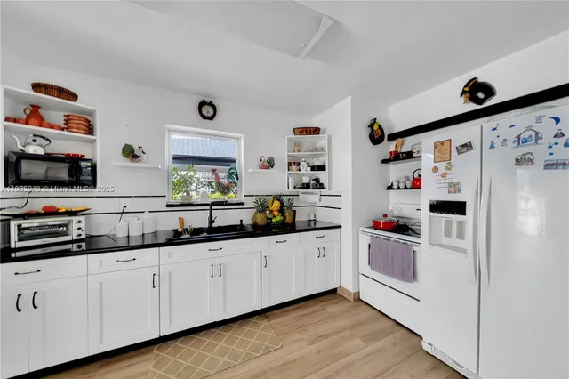 a kitchen with refrigerator and window