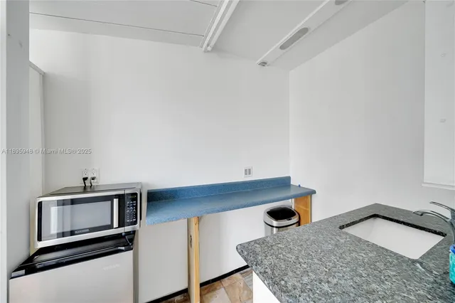 a room with a sink and a mirror