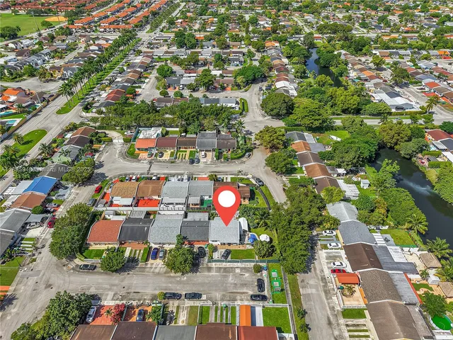 an aerial view of residential houses with outdoor space