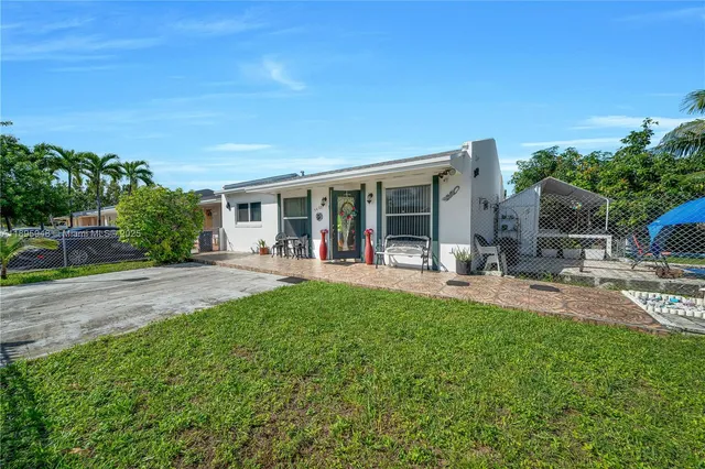 a view of a house with backyard porch and sitting area