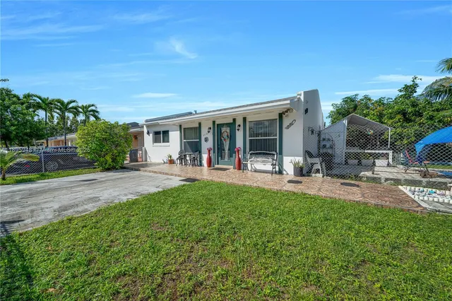 a view of a house with backyard porch and sitting area
