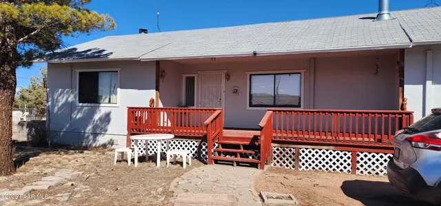 a view of a livingroom with furniture and a flat screen tv