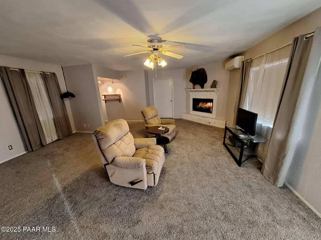 a bedroom with furniture and a ceiling fan
