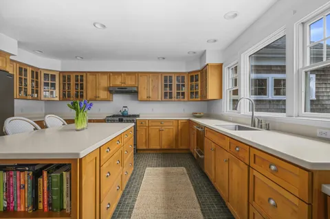 a kitchen with stainless steel appliances granite countertop a sink and cabinets