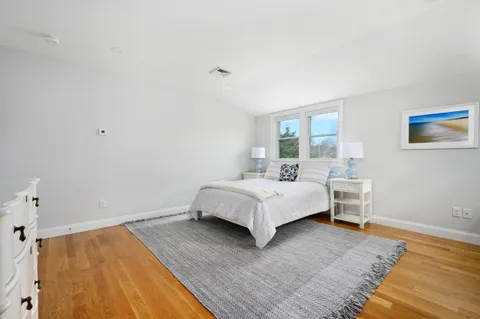 a bedroom with a bed and a night stand