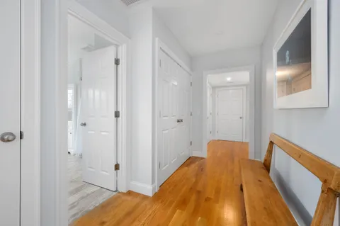 a view of a bedroom with wooden floor